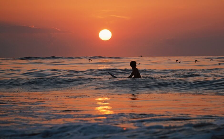 Surfing at sunset