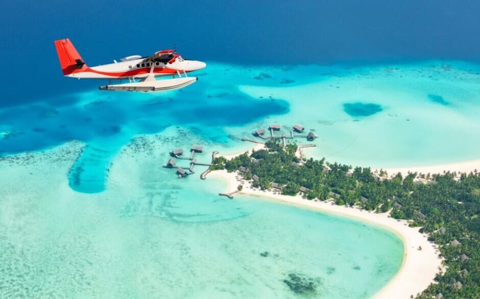 Sea plane flying above Maldives islands