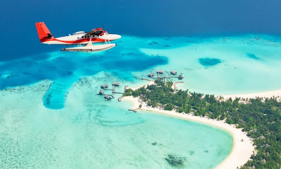 Sea plane flying above Maldives islands