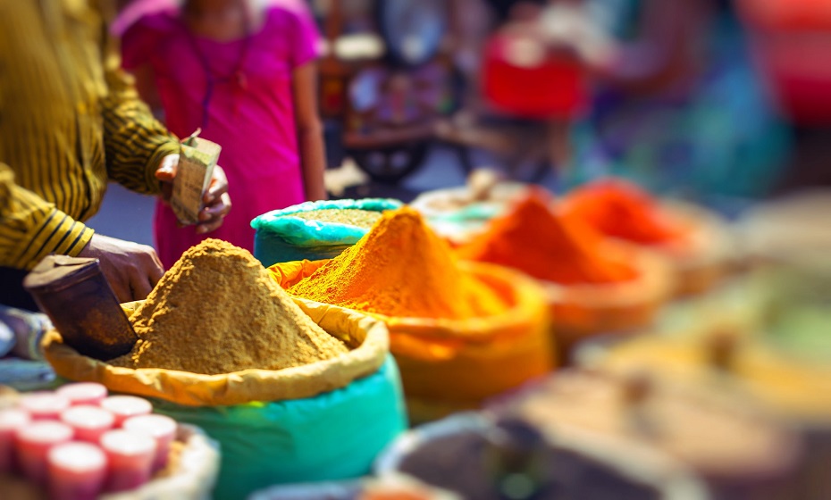 Colorful spices powders and herbs in traditional street market in Delhi