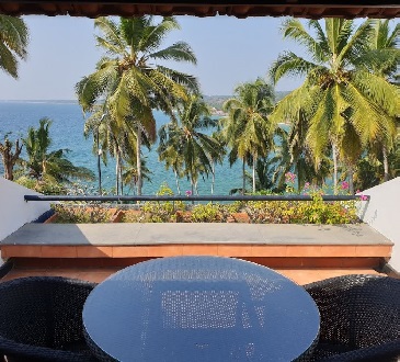 Client balcony photo with view of the sea and palm trees