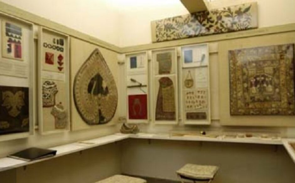 Interior of the Calico Museum, Ahmedabad. Textiles are on display in cases.
