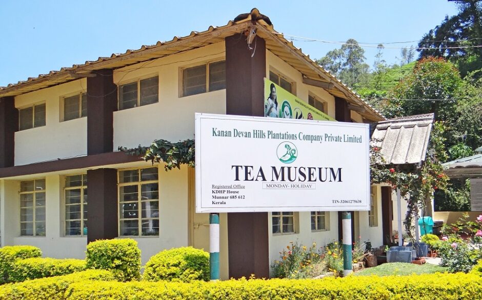 Exterior of the Kanan Devan Tea Museum, Munnar. THere is a large sign saying tea museum.