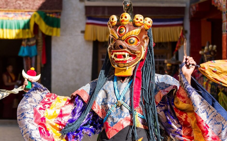 Performer wearing a brightly coloured mask at Cham Dance Festival in Lamayuru monastery, Ladakh