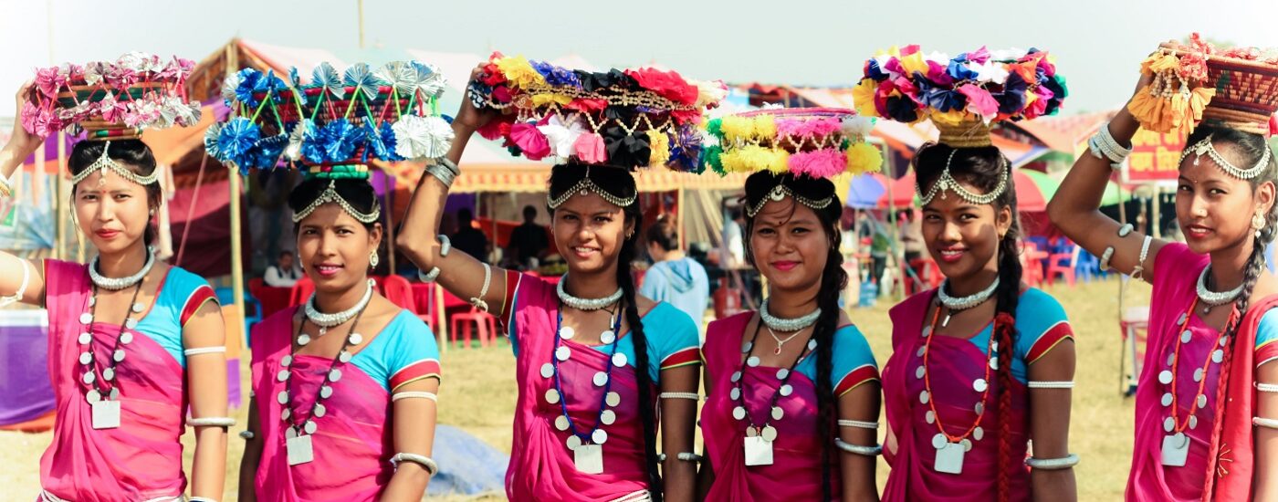 Best Festivals in Nepal - Nepalese women in bright pink dress wearing Dhakiya