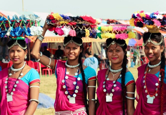 Best Festivals in Nepal - Nepalese women in bright pink dress wearing Dhakiya
