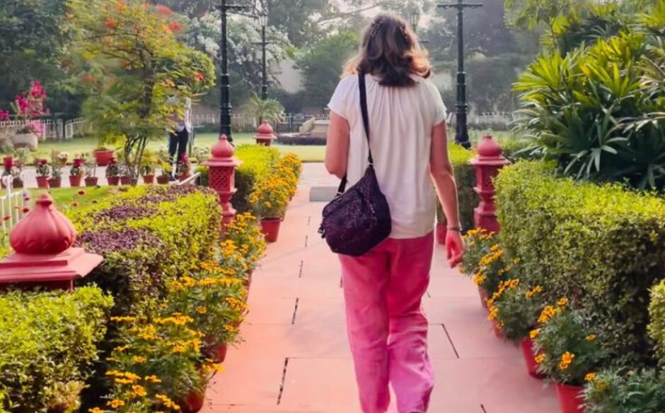 Photo of Jocelyn walking away in park grounds on a sunny day